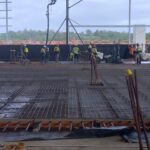 Construction workers are working on setting up a worksite and shotcrete for the construction of Woolworths' Moorebank distribution centers.